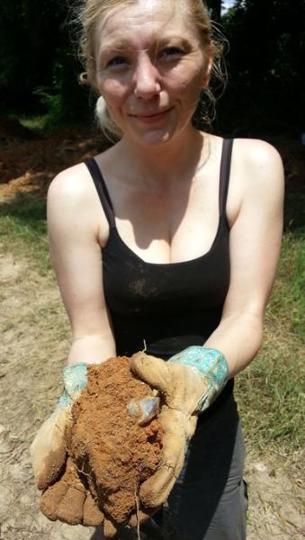 A visitor is shown with an amethyst crystal she found at our crystal dig place